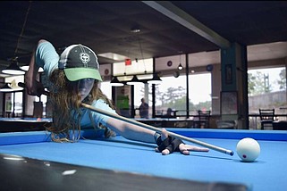 Jonah Freeman, a 14-year-old junior pool player, plays a round at Boondocks Billiards. Freeman is competing in his first major tournament this weekend in Shreveport, La. (The Sentinel-Record/Braden Sarver)